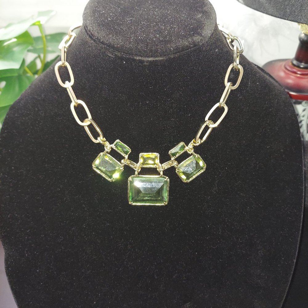 Gold chain link necklace with rectangular green gemstones